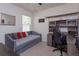 Well-lit bedroom with a daybed, carpet flooring, desk, shelving, and plenty of room for a comfortable living space at 1287 Berry Ln, Davenport, FL 33837