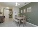 Bright dining room with stylish table set for four, modern mirrors, and neutral colors at 1287 Berry Ln, Davenport, FL 33837