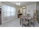 Inviting dining area featuring a table set, large window, and view into the hallway at 1287 Berry Ln, Davenport, FL 33837