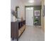 Inviting entryway with decorative console table, a mirror, stylish artwork, and neutral paint colors at 1287 Berry Ln, Davenport, FL 33837