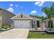 Charming single-Gathering home with a well-manicured lawn, inviting entry, and two-car garage at 1287 Berry Ln, Davenport, FL 33837