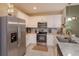 Well-equipped kitchen featuring stainless steel appliances, modern countertops, and white cabinetry at 1287 Berry Ln, Davenport, FL 33837