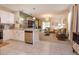 Open-concept living room with white cabinets, stainless steel appliances, and view to the living room area at 1287 Berry Ln, Davenport, FL 33837