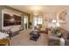 Bright living room featuring a ceiling fan, carpet flooring, modern furniture, and sliding doors leading to the outside at 1287 Berry Ln, Davenport, FL 33837