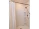 Bright shower featuring a rainfall shower head, built-in shower niche, and a curved shower rod with a white shower curtain at 1287 Berry Ln, Davenport, FL 33837