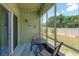 Enclosed sunroom with backyard view features wood-look tile flooring and natural light at 1287 Berry Ln, Davenport, FL 33837