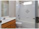 Clean bathroom with tub, shower, and a single sink with wood cabinet and white countertop at 1322 Reagans Reserve Blvd, Apopka, FL 32712