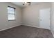 Bedroom with neutral carpet, window with blinds, and a white door at 1322 Reagans Reserve Blvd, Apopka, FL 32712