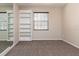 Carpeted bedroom with window, built-in shelving, and neutral paint at 1322 Reagans Reserve Blvd, Apopka, FL 32712