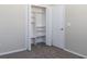 A closet with white shelving and white bi-fold doors, with carpeting to match the room at 1322 Reagans Reserve Blvd, Apopka, FL 32712