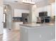 Spacious kitchen with white cabinets, stainless steel appliances, and a mosaic tile backsplash at 1322 Reagans Reserve Blvd, Apopka, FL 32712