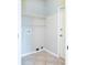 Laundry room with tile flooring, washer hookups, and wire shelving for storage at 1322 Reagans Reserve Blvd, Apopka, FL 32712