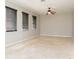 Open living room with tile flooring, three windows with blinds, and a ceiling fan at 1322 Reagans Reserve Blvd, Apopka, FL 32712