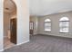 Inviting living room featuring large windows, neutral walls, and plush gray carpeting at 1322 Reagans Reserve Blvd, Apopka, FL 32712