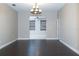 Open living room with hardwood floors and natural light from adjacent rooms at 1322 Reagans Reserve Blvd, Apopka, FL 32712