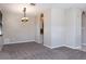 Open-concept living room featuring neutral walls, a modern light fixture, and plush carpeting at 1322 Reagans Reserve Blvd, Apopka, FL 32712