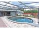Refreshing screened-in pool surrounded by a paver patio and a well-maintained backyard at 1322 Reagans Reserve Blvd, Apopka, FL 32712