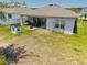 A spacious backyard perfect for entertaining, with patio, outdoor dining and playhouse at 14357 Hidden Ct, Clermont, FL 34711