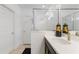 Bright bathroom featuring a sleek vanity, modern fixtures, and a glass-enclosed shower at 14357 Hidden Ct, Clermont, FL 34711