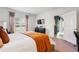 Bright bedroom with a large window, comfortable bed, and views of the backyard at 14357 Hidden Ct, Clermont, FL 34711
