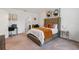 Stylish bedroom with a tufted headboard, comfortable bed, and a glimpse of the en-suite bathroom at 14357 Hidden Ct, Clermont, FL 34711