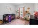 Charming Bedroom with crib, pink accents, and a playful kitchen set, creating a cozy and inviting space at 14357 Hidden Ct, Clermont, FL 34711
