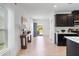 Stylish entryway featuring wood-look floors, a table, and a glimpse of the modern kitchen at 14357 Hidden Ct, Clermont, FL 34711