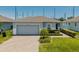 Charming single-story home with a well-manicured lawn and a two car garage at 14357 Hidden Ct, Clermont, FL 34711