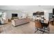 Open-concept living room showcases modern furnishings, tile flooring, and seamless flow to the kitchen and dining area at 14357 Hidden Ct, Clermont, FL 34711