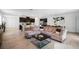 Spacious open-concept living area with stylish decor, wood floors, and a modern kitchen at 14357 Hidden Ct, Clermont, FL 34711