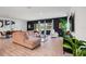 Bright living room features wood floors, large windows, and elegant black accent wall at 14357 Hidden Ct, Clermont, FL 34711