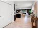 Spacious open-concept living room featuring wood-look tile flooring, natural light, and open flow into kitchen at 14357 Hidden Ct, Clermont, FL 34711