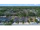 Aerial view of townhomes in a community surrounded by lush greenery and conveniently located near urban amenities at 150 Mitchell Creek Way, Oviedo, FL 32765