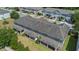 Aerial perspective of townhome exteriors displaying covered patios and manicured lawns, highlighting community living at 150 Mitchell Creek Way, Oviedo, FL 32765