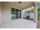 Covered back patio with privacy fence and sliding glass doors to the home's interior at 150 Mitchell Creek Way, Oviedo, FL 32765