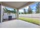 Covered back patio with privacy fence and small landscaping at 150 Mitchell Creek Way, Oviedo, FL 32765