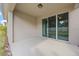 Covered back patio with sliding glass doors to home's interior, privacy fence and small landscaping at 150 Mitchell Creek Way, Oviedo, FL 32765