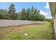 Spacious backyard with a stone-look fence, offering privacy and ample green space for outdoor activities at 150 Mitchell Creek Way, Oviedo, FL 32765