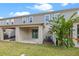 Backyard featuring a covered patio area and lush landscaping, offering a private outdoor living space at 150 Mitchell Creek Way, Oviedo, FL 32765