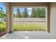 A view of the backyard from the covered patio, showing a well-maintained yard and stone wall at 150 Mitchell Creek Way, Oviedo, FL 32765