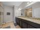 Bathroom featuring granite counters, double sinks, and tiled walk-in shower at 150 Mitchell Creek Way, Oviedo, FL 32765