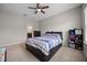 Bedroom featuring a ceiling fan, natural light, and a patterned comforter at 150 Mitchell Creek Way, Oviedo, FL 32765