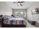 Bedroom features a ceiling fan, natural light, and a patterned comforter at 150 Mitchell Creek Way, Oviedo, FL 32765