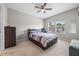 Bedroom features a ceiling fan, natural light, and a patterned comforter at 150 Mitchell Creek Way, Oviedo, FL 32765