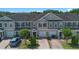 A row of townhomes featuring neutral tones, single-car garages, and brick-paved driveways at 150 Mitchell Creek Way, Oviedo, FL 32765