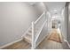 Inviting hallway with wood-look tile flooring, staircase, and multiple doors at 150 Mitchell Creek Way, Oviedo, FL 32765