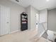 Upstairs hallway with carpet, a bookshelf, and access to additional rooms at 150 Mitchell Creek Way, Oviedo, FL 32765