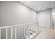 Upstairs hallway with white railing, carpeted stairs, a closet, and access to other rooms at 150 Mitchell Creek Way, Oviedo, FL 32765