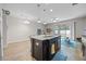 Open floor plan with a kitchen island featuring a sink, bar seating, and stylish pendant lighting at 150 Mitchell Creek Way, Oviedo, FL 32765