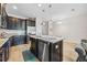Granite kitchen island with stainless steel dishwasher and drop lighting at 150 Mitchell Creek Way, Oviedo, FL 32765